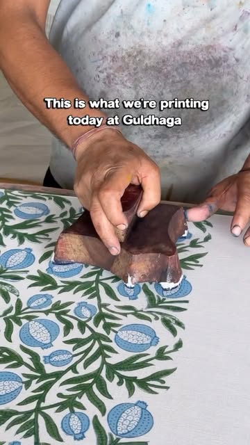 A pomegranate motif being registered by hand